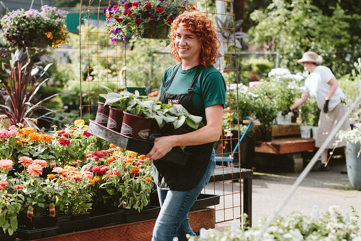 garden center worker holding plants