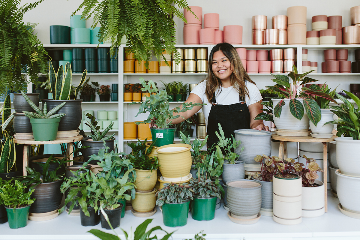 Employee Holding Plants at Bridgeport Village - Plant Shop Jobs & Careers at Dennis' 7 Dees