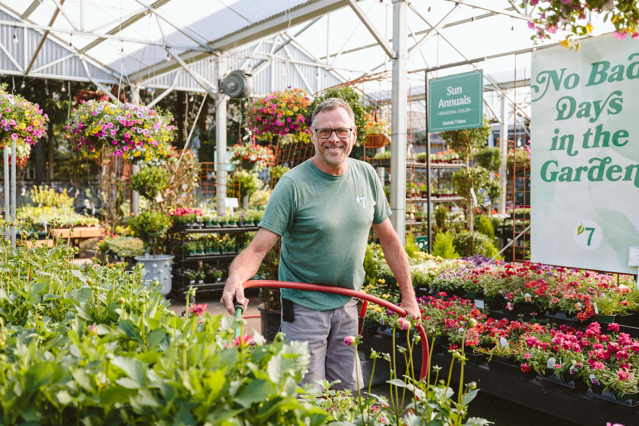 watering plants at Dennis' 7 Dees garden center